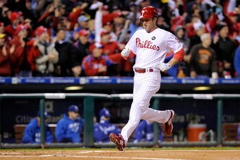 PHILADELPHIA - OCTOBER 18:  Chase Utley #26 of the Philadelphia Phillies scores on a triple by Ryan Howard in the first inning against the Los Anageles Dodgers in Game Three of the NLCS during the 2009 MLB Playoffs at Citizens Bank Park on October 18, 200