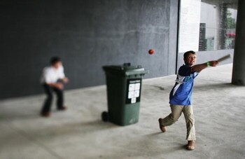 MELBOURNE, AUSTRALIA - DECEMBER 27: (THIS IMAGE WAS CREATED USING A VARIABLE PLANED LENS) Kids play cricket using a toy bat and a wheelie bin during the fourth Ashes test at the Melbourne Cricket Ground December 27, 2006 in Melbourne, Australia. The Ashes
