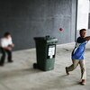 MELBOURNE, AUSTRALIA - DECEMBER 27: (THIS IMAGE WAS CREATED USING A VARIABLE PLANED LENS) Kids play cricket using a toy bat and a wheelie bin during the fourth Ashes test at the Melbourne Cricket Ground December 27, 2006 in Melbourne, Australia. The Ashes