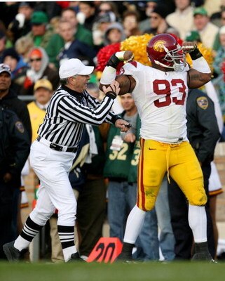 SOUTH BEND, IN - OCTOBER 17: The referee tries to stop Everson Griffen #93 of the USC Trojans from celebrating and is called for a penalty for taunting during the third quarter of the game against the Notre Dame Fighting Irish  at Notre Dame Stadium on Oc