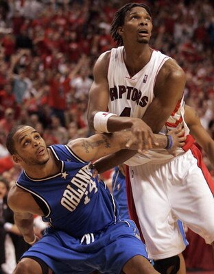 TORONTO,ON - APRIL 26:  Chris Bosh #4 of the Toronto Raptors tries to break away from Jameer Nelson #14 of the Orlando Magic in Game Four of the Eastern Conference Quarterfinals during the 2008 NBA Playoffs on April 26, 2008 at the Air Canada Centre in To
