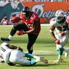 MIAMI - NOVEMBER 6:  Tight end Alge Crumpler #83 of the Atlanta Falcons jumps over cornerback Travis Daniels #21 of the Miami Dolphins after a pass reception on November 6, 2005 at Dolphins Stadium in Miami, Florida. The Falcons defeated the Dolphins 17-1