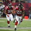 ATLANTA - JANUARY 15:  Allen Rossum #20 of the Atlanta Falcons runs against the defense of the St. Louis Rams during first half of the NFC Divisional Playoff game at the Georgia Dome on January 15, 2005 in Atlanta, Georgia.  (Photo by Streeter Lecka/Getty