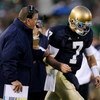 SOUTH BEND, IN - OCTOBER 17: Head coach Charlie Weis of the Notre Dame Fighting Irish speaks to quarterback Jimmy Clausen #7 during the fourth quarter against the USC Trojans at Notre Dame Stadium on October 17, 2009 in South Bend, Indiana. USC won the ga