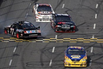 MARTINSVILLE, VA - OCTOBER 25:  Michael Waltrip, driver of the #55 NAPA Adaptive One Brakes Toyota, David Stremme, driver of the #12 Penske Dodge, and John Andretti, driver of the #34 A&W All American Hamburger Chevrolet, pass by Sam Hornish Jr., driver o