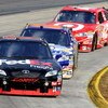 MARTINSVILLE, VA - OCTOBER 25:  Denny Hamlin, driver of the #11 FedEx Freight Toyota, leads David Reutimann, driver of the #00 Aaron's Dream Machine Toyota, and Juan Pablo Montoya, driver of the #42 Target Chevrolet, during the NASCAR Sprint Cup Series TU