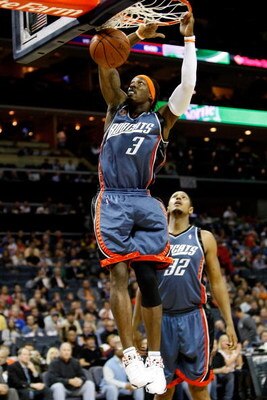 CHARLOTTE, NC - MARCH 28:  Boris Diaw #32 watches as his teammate Gerald Wallace #3 of the Charlotte Bobcats dunks the ball against the New York Knicks during their game at Time Warner Cable Arena on March 28, 2009 in Charlotte, North Carolina.  NOTE TO U
