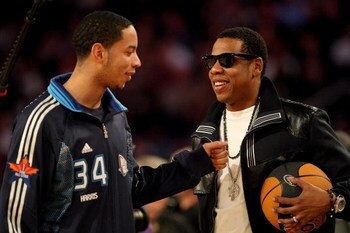 PHOENIX - FEBRUARY 15:  Rapper Jay-Z talks to Devin Harris #34 of the Eastern Conference during the 58th NBA All-Star Game, part of 2009 NBA All-Star Weekend at US Airways Center on February 15, 2009 in Phoenix, Arizona.  NOTE TO USER: User expressly ackn