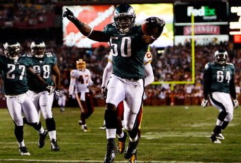 LANDOVER, MD - OCTOBER 26:  Line backer Will Witherspoon #50 of the Philadelphia Eagles crosses the goal line for a touchdown after an interception from quarterback Jason Campbell #17 of the Washington Redskins during the first quarter of the game at FedE