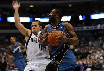 DALLAS - OCTOBER 27:  Guard Gilbert Arenas #0 of the Washington Wizards is fouled by Jose Juan Barea #11 of the Dallas Mavericks during the season opener on October 27, 2009 at American Airlines Center in Dallas, Texas.  NOTE TO USER: User expressly ackno
