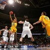 DENVER - MARCH 20:  Cam Long #20 of the George Mason Patriots lays up a shot against Zach Hillesland #33 of the Notre Dame Fighting Irish during the first round of the East Regional as part of the 2008 NCAA Men's Basketball Tournament at Pepsi Center on M