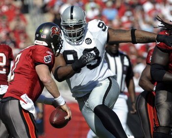 TAMPA, FL - DECEMBER 28: Defensive tackle Tommy Kelly #93 of the Oakland Raiders rushes quarterback Jeff Garcia #7 of the Tampa Bay Buccaneers at Raymond James Stadium on December 28, 2008 in Tampa, Florida.  (Photo by Al Messerschmidt/Getty Images)