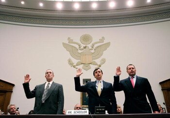 WASHINGTON - FEBRUARY 13:  Major League Baseball pitcher Roger Clemens (R), Charlie Scheeler, investigator on former Sen. George Mitchell's staff (C) and and former Major League Baseball strength and conditioning coach Brian McNamee (L) raise their right 