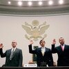 WASHINGTON - FEBRUARY 13:  Major League Baseball pitcher Roger Clemens (R), Charlie Scheeler, investigator on former Sen. George Mitchell's staff (C) and and former Major League Baseball strength and conditioning coach Brian McNamee (L) raise their right 
