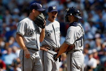 CHICAGO, IL - SEPTEMBER 18: Coach Mike Maddux #36, pitcher Dave Bush #31 and catcher Jason Kendall #18 of the Milwaukee Brewers talk on the pitching mound during a time out against the Chicago Cubs at the Wrigley Field on September 18, 2008 in Chicago, Il