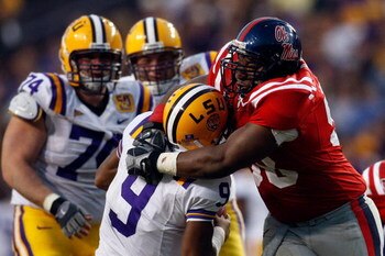 BATON ROUGE, LA - NOVEMBER 22:  Quarterback Jordan Jefferson #9 of the Louisiana State University Tigers is sacked by Peria Jerry #98 of the Ole Miss Rebels on November 22, 2008 at Tiger Stadium in Baton Rouge, Louisiana.  The Rebels defeated the Tigers 3