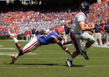 GAINESVILLE, FL - SEPTEMBER 27:  Quarterback Jevan Snead #4 of the Ole Miss Rebels runs for a touchdown against Brnadon Hicks #40 of the Florida Gators during the game at Ben Hill Griffin Stadium on September 27, 2008 in Gainesville, Florida.  (Photo by S