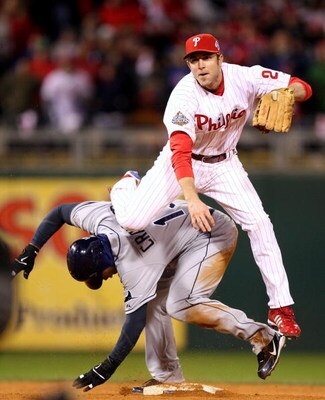 PHILADELPHIA - OCTOBER 29:  Chase Utley #26 of the Philadelphia Phillies turns a successful double play over Carl Crawford #13 of the Tampa Bay Rays on a ball hit by B.J. Upton #2 in the top of the eighth inning during the continuation of game five of the