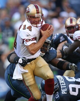 SEATTLE - SEPTEMBER 14:  Quarterback J.T. O'Sullivan #14 of the San Francisco 49ers is tackled by Brandon Mebane #92 of the Seattle Seahawks on September 14, 2008 at Qwest Field in Seattle Washington. The 49ers defeated the Seahawks 33-30 in overtime. (Ph