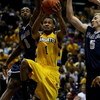 MILWAUKEE - JANUARY 31: Dominic James #1 of the Marquette Golden Eagles goes up for a shot against DaJuan Summers #3 and Nikita Mescheriakov #5 of the Georgetown Hoyas on January 31, 2009 at the Bradley Center in Milwaukee, Wisconsin. Marquette defeated G