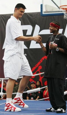 SHANGHAI, CHINA - SEPTEMBER 25:  (CHINA OUT) NBA star Allen Iverson (R) of USA and Yao Ming of China shake hands during an event at Shanghai Stadium on September 25, 2005 in Shanghai, China. Philadelphia 76ers guard Allen Iverson is visiting Shanghai as t