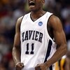 PHOENIX - MARCH 27:  B.J. Raymond #11 of the Xavier Musketeers celebrates a three pointer in the final minutes of overtime during the West Regional Sweet 16 game against West Virginia Mountaineers at the U.S. Airways Center on March 27, 2008 in Phoenix, A