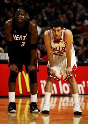 CHICAGO - FEBRUARY 12: Kirk Hinrich #12 of the Chicago Bulls and Dwyane Wade #3 of the Miami Heat wait together for a free-throw attempt on February 12, 2009 at the United Center in Chicago, Illinois. The Heat defeated the Bulls 95-93. NOTE TO USER: User 