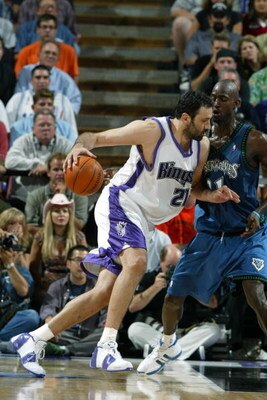SACRAMENTO, CA - MAY 12:  Vlade Divac #21 of the Sacramento Kings drives around Kevin Garnett #21 of the Minnesota Timberwolves in Game four of the Western Conference Semifinals during the 2004 NBA Playoffs at Arco Arena on May 12, 2004 in Sacramento, Cal