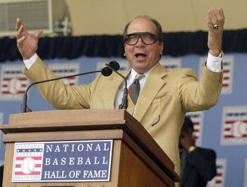 COOPERSTOWN, NY - JULY 25:  Johnny Bench, former Cinncinnatti Reds Hall of Fame catcher, does his 'Harry Caray' imitation as he leads the crowd in 'Take Me Out to the Ball Game'    during the National Baseball Hall of Fame Induction Ceremonies on July 25,