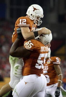 GLENDALE, AZ - JANUARY 05:  Quarterback Colt McCoy #12 of the Texas Longhorns celebrates with Cedric Dockery #55 after McCoy scored on a 14 yard touchdown rush against the Ohio State Buckeyes during the third quarter of the Tostitos Fiesta Bowl Game on Ja