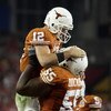 GLENDALE, AZ - JANUARY 05:  Quarterback Colt McCoy #12 of the Texas Longhorns celebrates with Cedric Dockery #55 after McCoy scored on a 14 yard touchdown rush against the Ohio State Buckeyes during the third quarter of the Tostitos Fiesta Bowl Game on Ja