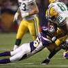 MINNEAPOLIS - NOVEMBER 09:  Running back Ryan Grant #25 of the Green Bay Packers carries the ball against cornerback Antoine Winfield #26 of the Minnesota Vikings on November 9, 2008 at the Metrodome in Mineapolis, Minnesota.  The Vikings won 28-27.  (Pho