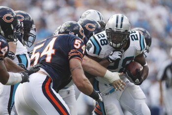 CHARLOTTE, NC - SEPTEMBER 14:  Jonathan Stewart #28 of the Carolina Panthers runs the ball against Brian Urlacher #54 of the Chicago Bears during their NFL game at Bank of America Stadium in Charlotte, North Carolina on September 14, 2008. (Photo by: Stre