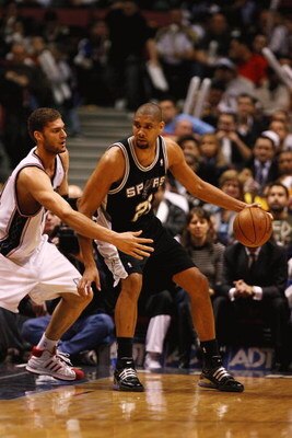 EAST RUTHERFORD, NJ - FEBRUARY 10:  Tim Duncan #21 of the San Antonio Spurs dribbles against Brook Lopez #11 of The New Jersey Nets during their game on February 10, 2009 at The Izod Center in East Rutherford, New Jersey.  NOTE TO USER: User expressly ack