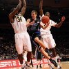 NEW YORK - NOVEMBER 21:  Jon Scheyer #30 of the Duke Blue Devils goes to the basket between DeShawn Sims #34 and Manny Harris #3 of the Michigan Wolverines on November 21, 2008 at Madison Square Garden in New York City.  (Photo by Nick Laham/Getty Images)