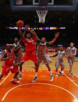 NEW YORK - MARCH 10:  Sean Evans #5 of the St. John's Red Storm goes to the hoop againstJulian Vaughn #22 of the Georgetown Hoyas  during the first round of the Big East Tournament at Madison Square Garden on March 10, 2009 in New York City.  (Photo by Ch