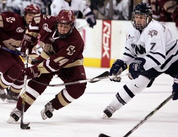 BOSTON - MARCH 17:  Matt Greene #14 of the Boston College Eagles skates past Joe Charlebois #7 of the New Hampshire Wildcats during the Hockey East Tournament on March 17,2007 at TD Banknorth Garden in Boston, Massachusetts. Boston College defeated New Ha