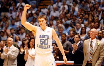 CHAPEL HILL, NC - MARCH 08:  Tyler Hansbrough #50 of the North Carolina Tar Heels thanks fans as his head coach Roy Williams(L) and father, Gene (R), watch on before the start of their game against the Duke Blue Devils on senior night at the Dean E. Smith