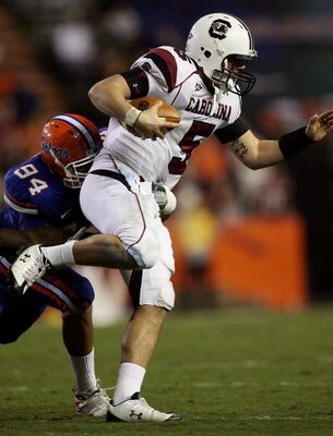 GAINESVILLE, FL - NOVEMBER 15:  Justin Trattou #94 of the Florida Gators sacks quarterback Stephen Garcia #5 of the South Carolina Gamecocks at Ben Hill Griffin Stadium on November 15, 2008 in Gainesville, Florida. Florida defeated South Carolina 56-6.  (