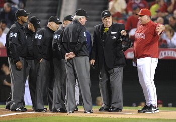 ANAHEIM, CA - OCTOBER 08:  Mike Scioscia #14 manager of the Los Angeles Angels of Anaheim speaks to the umpires at the start Game One of the ALDS against the Boston Red Sox during the 2009 MLB Playoffs at Angel Stadium on October 8, 2009 in Anaheim, Calif