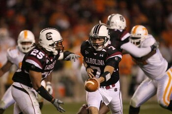 COLUMBIA, SC - NOVEMBER 01:  Chris Smelley #7 of the South Carolina Gamecocks hands the ball off to teammate Mike Davis #25 during their game against the Tennessee Volunteers at Williams-Brice Stadium on November 1, 2008 in Columbia, South Carolina.  (Pho