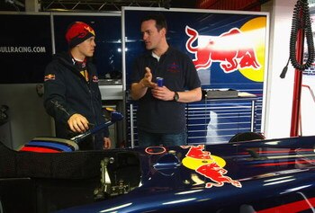 BARCELONA, SPAIN - MARCH 12:  Sebastian Vettel of Germany and team Red Bull Racing shows Red Bull air race pilot Matthias Dolderer his car during formula one testing at the Circuit de Catalunya on March 12, 2009 in Barcelona, Spain.  (Photo by Mark Thomps