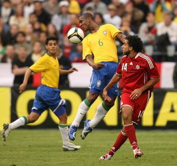 SEATTLE - MAY 31:  Gilberto #6 of Brazil heads the ball against Dwayne De Rosario #14 of Canada on May 31, 2008 at Qwest Field in Seattle, Washington. Brazil defeated Canada 3-2. (Photo by Otto Greule Jr/Getty Images)