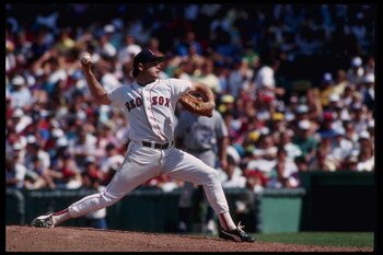 24 Dec 1996: Pitcher Roger Clemens of the Boston Red Sox winds up to throw a fast ball at Fenway Park in Boston, Massachusetts.