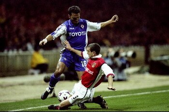 27 Oct 1999:  Nigel Winterburn of Arsenal slides in to tackle Angelo Di Livio of Fiorentina during the UEFA European Champions League Group B match played at Wembley Stadium, London. The game finished in a 1-0 away win for Fiorentina and saw the eliminati