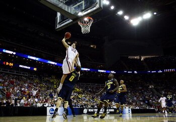 KANSAS CITY, MO - MARCH 21:  Blake Griffin #23 of the Oklahoma Sooners jumps to the net for the slam dunk against Zack Novak #0 of the Michigan Wolverines during the second round of the NCAA Division I Men's Basketball Tournament at the Sprint Center on M