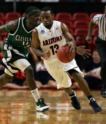 MIAMI - MARCH 22:  Guard Nic Wise #13 of the  University of Arizona Wildcats steals the ball from guard Cedric Jackson #11 of the Cleveland State University Vikings during the second round of the NCAA Division I Men's Basketball Tournament at the American