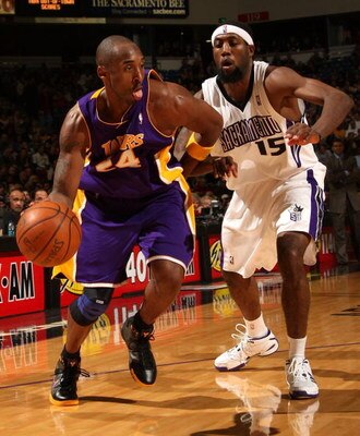 SACRAMENTO, CA - DECEMBER 09: Kobe Bryant #24 of the Los Angeles Lakers drives past John Salmons #15 of the Sacramento Kings during an NBA game on December 9, 2008 at ARCO Arena in Sacramento, California. NOTE TO USER: User expressly acknowledges and agre