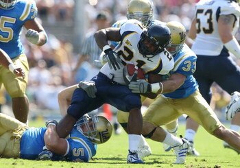 PASADENA, CA - OCTOBER 20:   James Montgomery #21 of the California Golden Bears is tackled by the UCLA Bruins defense during the game at the Pasadena Rose Bowl on October 20, 2007 in Pasadena, California.  (Photo by Lisa Blumenfeld/Getty Images)