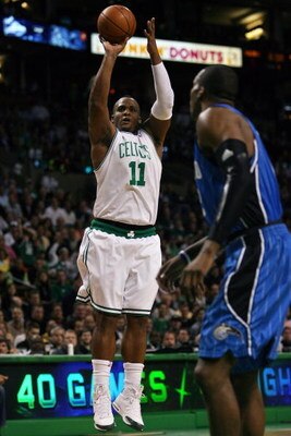 BOSTON - MAY 12:  Glen Davis #11 of the Boston Celtics takes a shot as Dwight Howard #12 of the Orlando Magic defends in Game Five of the Eastern Conference Semifinals during the 2009 NBA Playoffs at TD Banknorth Garden May 12, 2009 in Boston, Massachuset